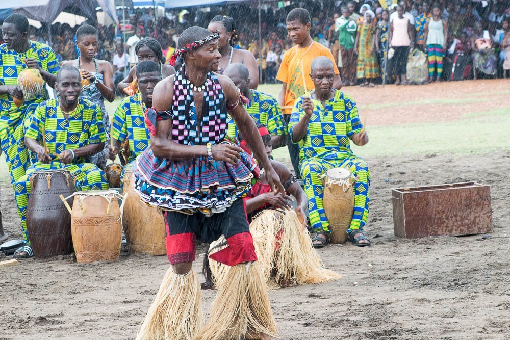 Dancers in traditional cloth performing with drummers