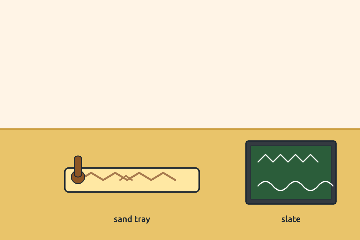 A child tracing zigzag patterns in a tray of sand