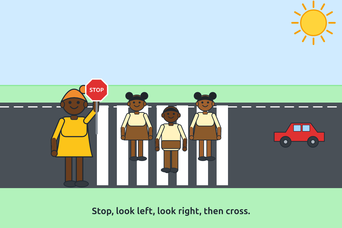Children crossing the road safely with a crossing guard