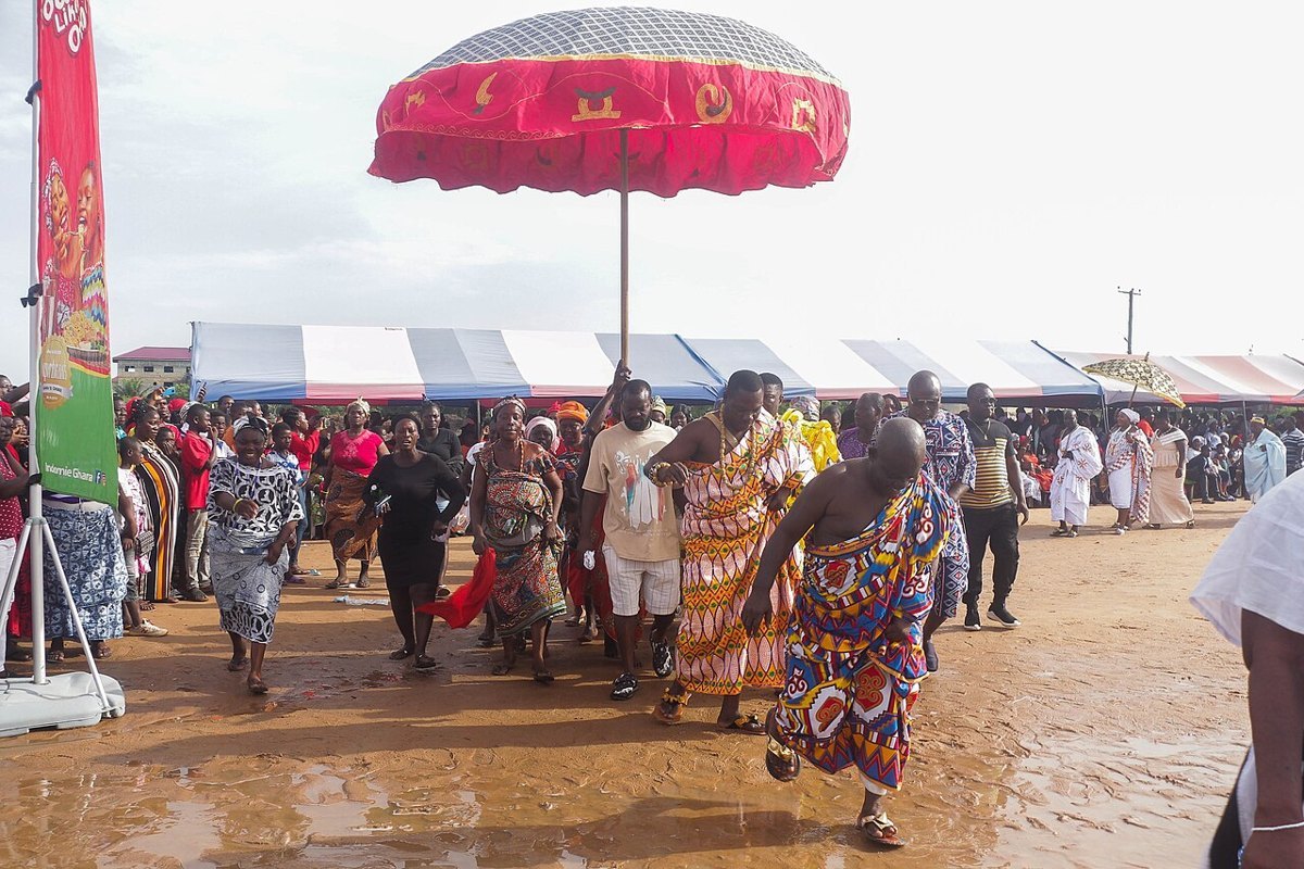 A Ghanaian chief at a durbar with drummers and a crowd