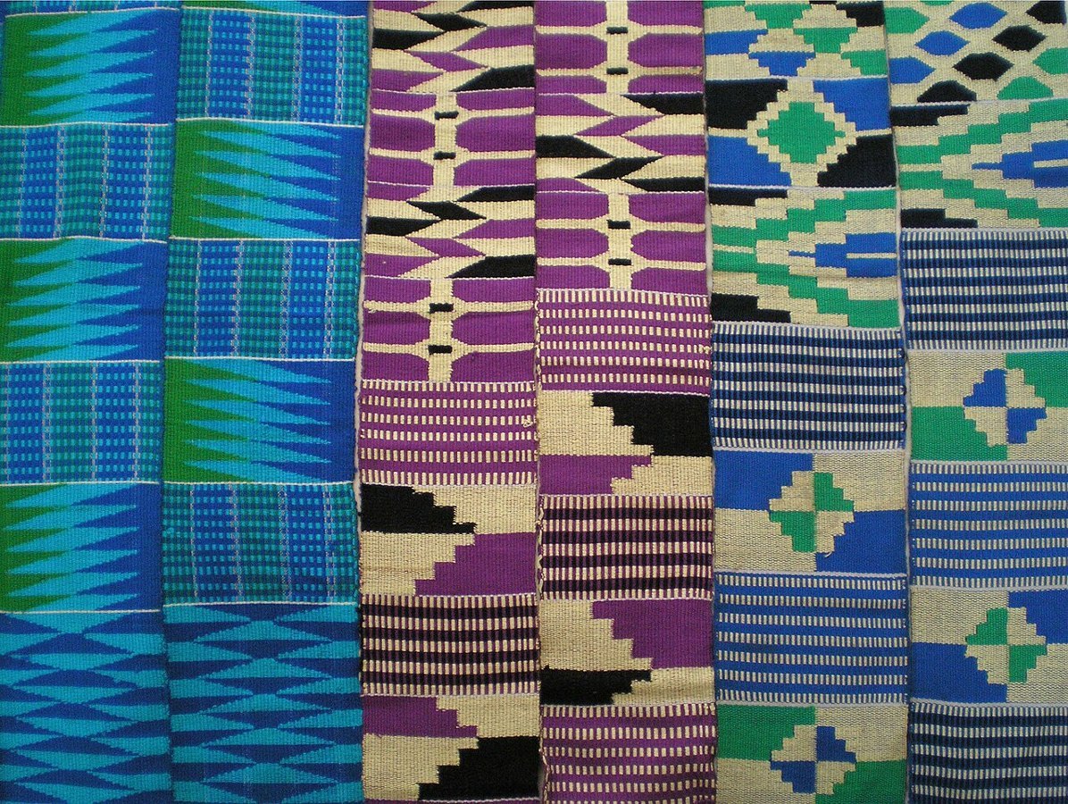 A close-up of kente cloth with its colours and repeating patterns