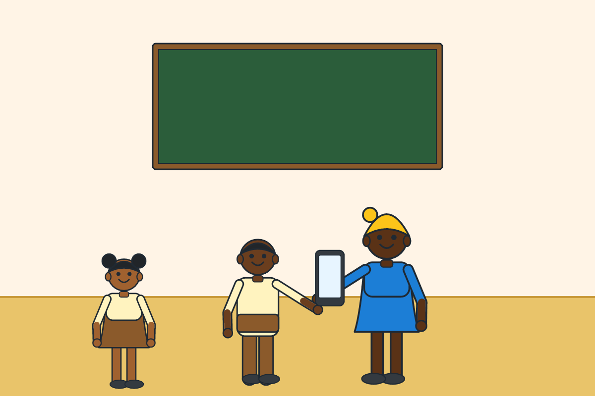 A boy handing a found phone to his teacher