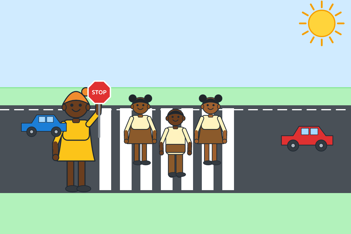Children crossing a road at a zebra crossing with a warden