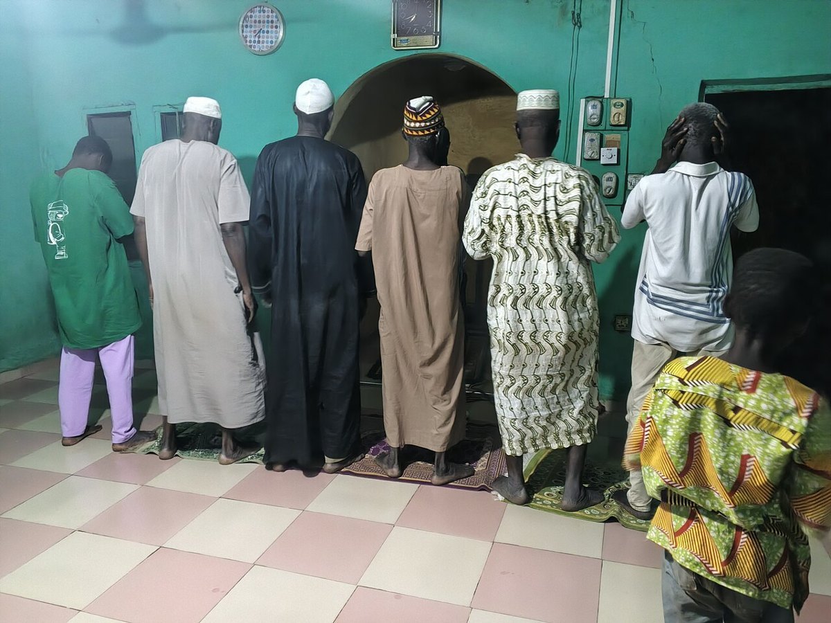 Muslims praying in rows in a mosque