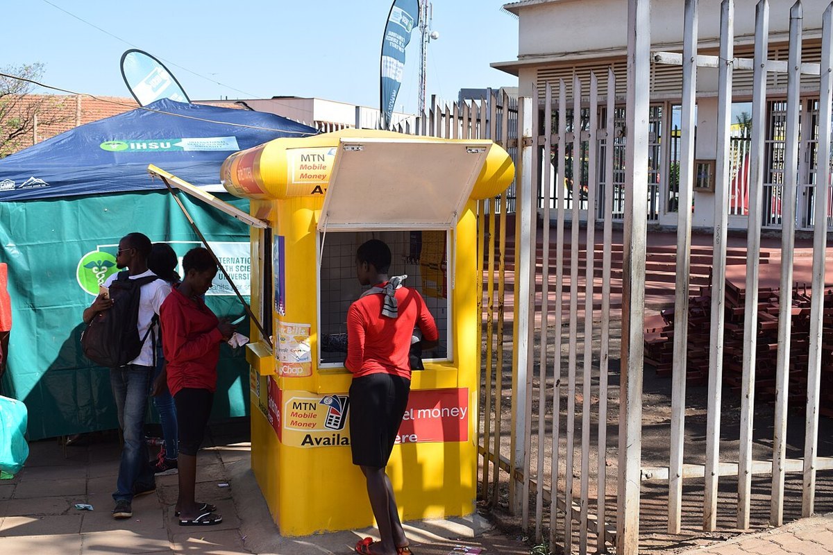 A mobile money kiosk with a customer and agent