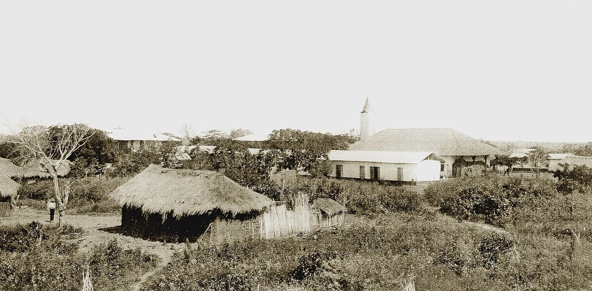 An old mission church building with a hospital nearby
