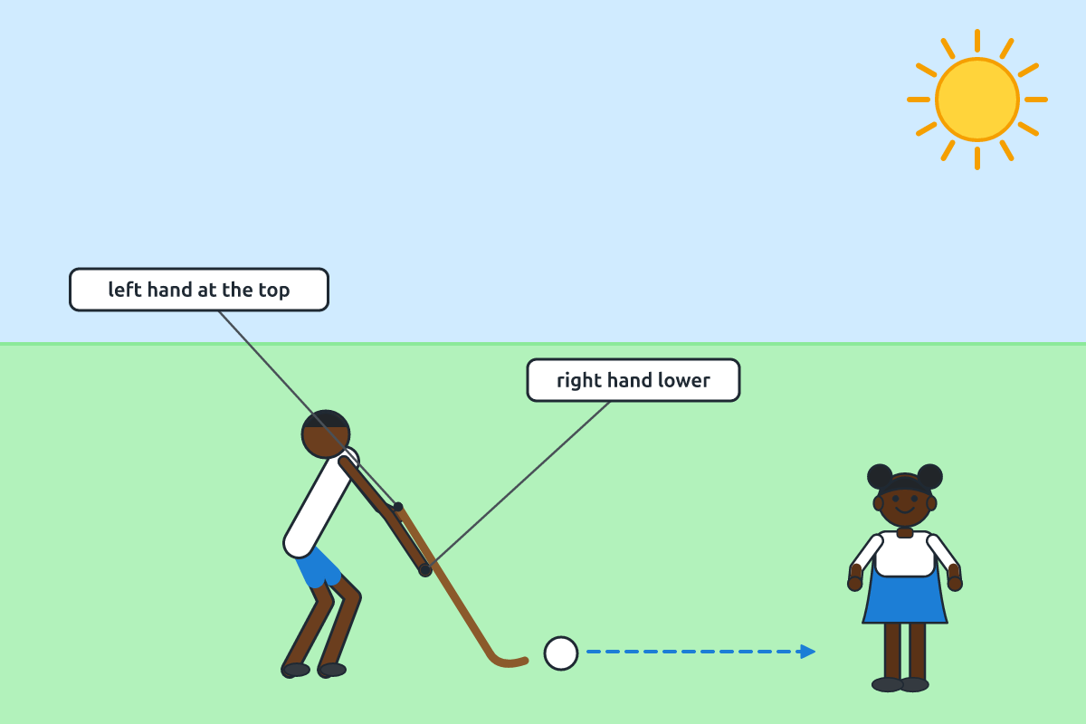 A pupil making a push pass with a hockey stick